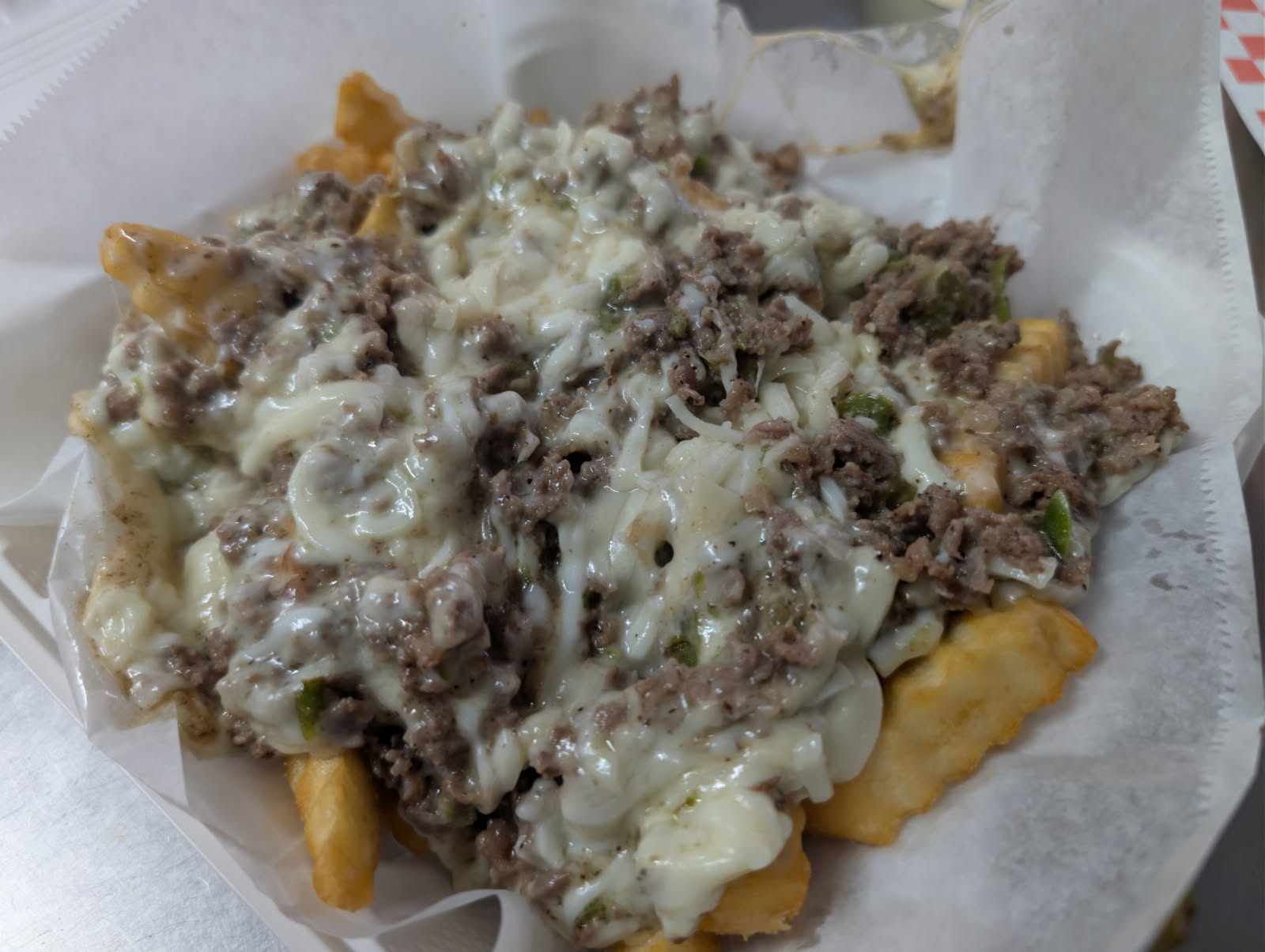 Cheesesteak Fries topped with steak and peppers